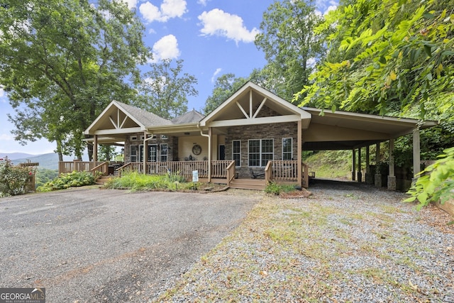 view of front of house featuring a mountain view, a carport, and covered porch