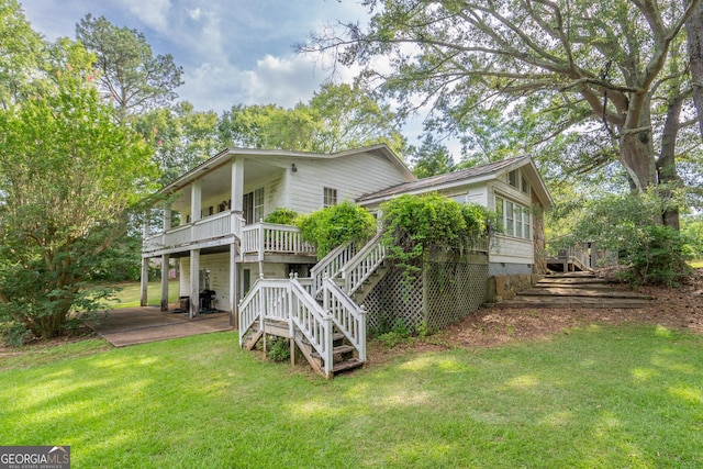 back of property featuring a yard and a deck