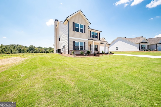 view of front of home with a front lawn and central AC unit