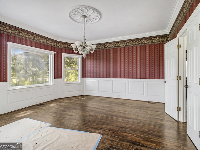 unfurnished dining area featuring crown molding, a chandelier, and dark hardwood / wood-style floors