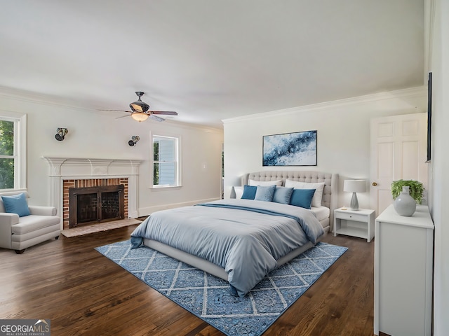 bedroom with ceiling fan, a fireplace, crown molding, and dark wood-type flooring