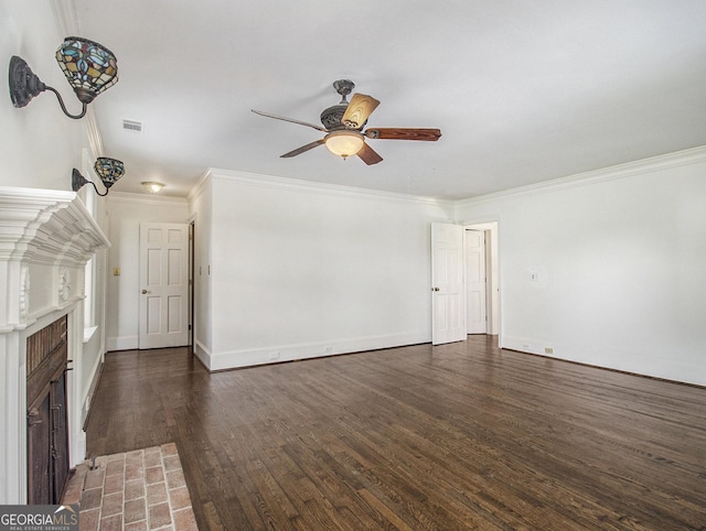 unfurnished living room featuring ceiling fan, dark hardwood / wood-style flooring, ornamental molding, and a fireplace