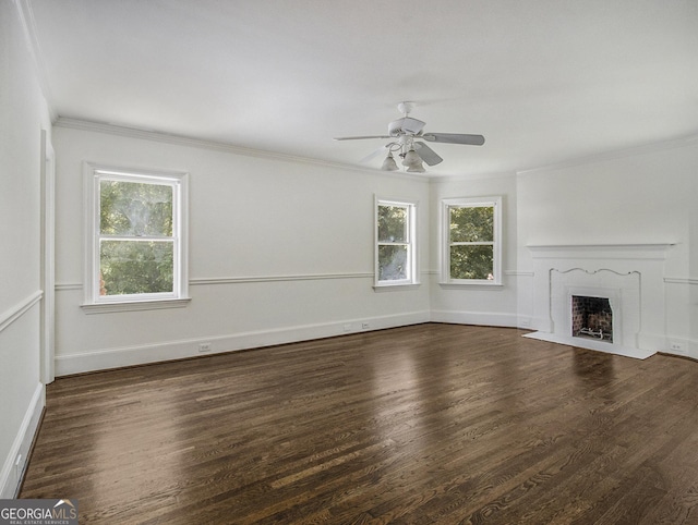 unfurnished living room with a high end fireplace, dark wood-type flooring, ceiling fan, and crown molding