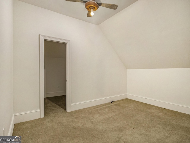 additional living space featuring light carpet, ceiling fan, and lofted ceiling