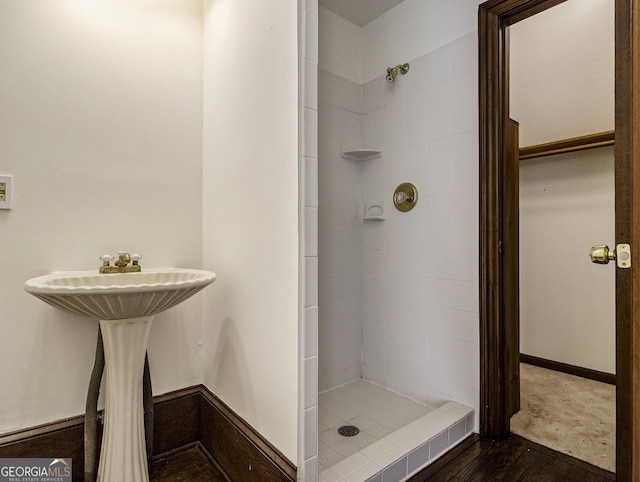 bathroom featuring tiled shower and hardwood / wood-style flooring