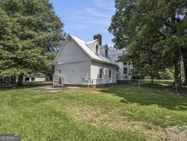 rear view of property with a yard