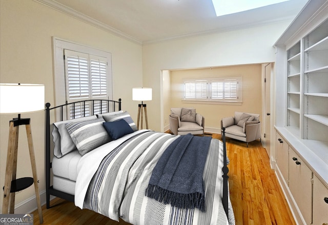 bedroom with crown molding and light hardwood / wood-style flooring