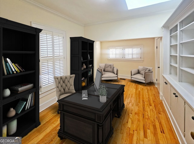 home office featuring a wealth of natural light, light hardwood / wood-style flooring, and crown molding