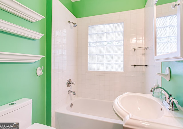 full bathroom with toilet, tiled shower / bath, and sink