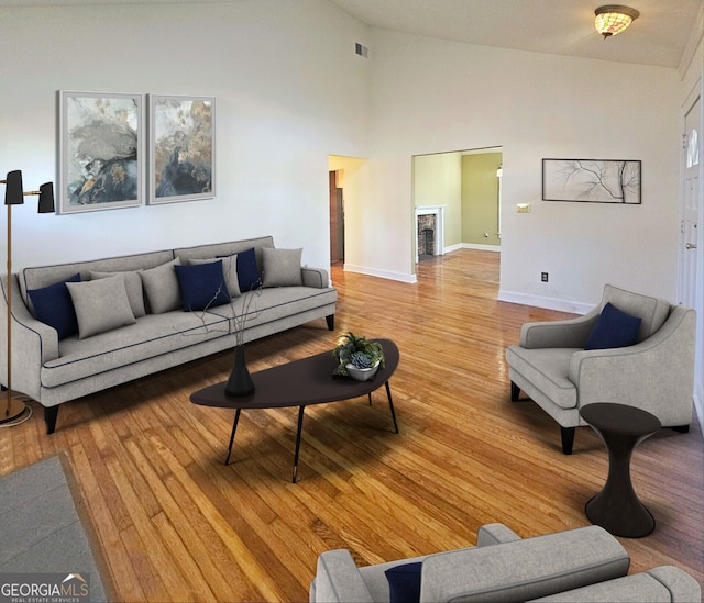 living room with hardwood / wood-style flooring and high vaulted ceiling