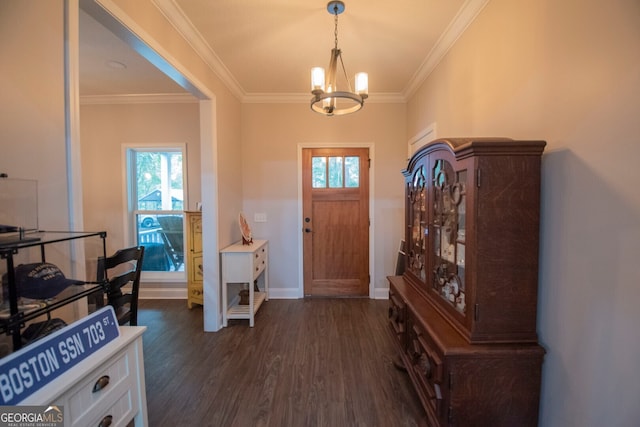 entrance foyer with dark wood-type flooring, a chandelier, plenty of natural light, and crown molding