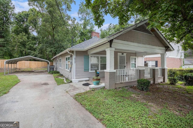 bungalow-style house featuring covered porch and a carport