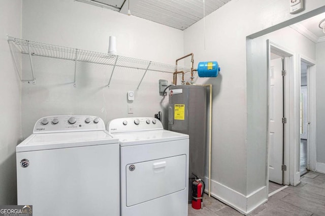 clothes washing area with washing machine and dryer, crown molding, water heater, and light tile patterned floors