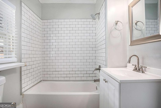 full bathroom with vanity, tiled shower / bath, and toilet