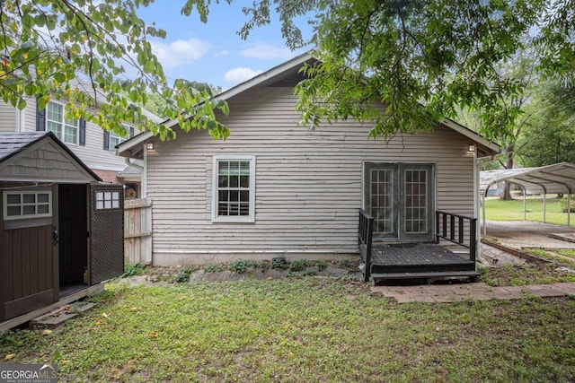 back of property featuring a carport, a yard, and a storage shed