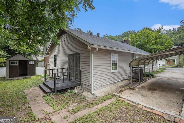 view of property exterior with a storage shed and a carport