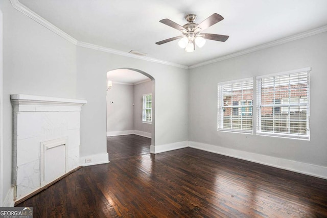 unfurnished living room featuring ceiling fan, wood-type flooring, and ornamental molding