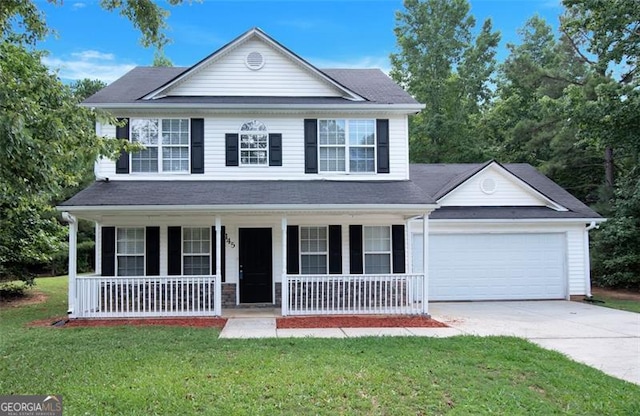 front facade featuring a front yard, a porch, and a garage