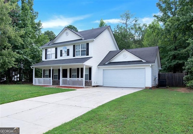 view of front of house with a front lawn, covered porch, and a garage