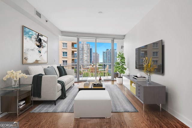 living room with expansive windows and hardwood / wood-style flooring