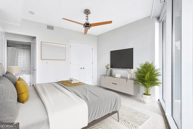 bedroom featuring connected bathroom, ceiling fan, and carpet