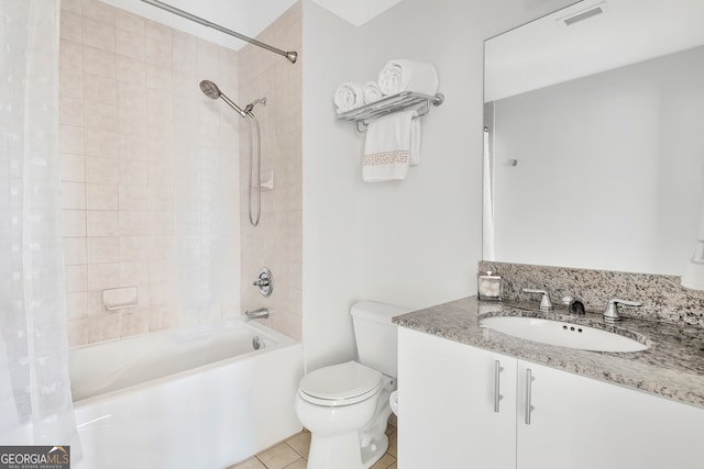 full bathroom with shower / tub combo with curtain, vanity, tile patterned flooring, and toilet