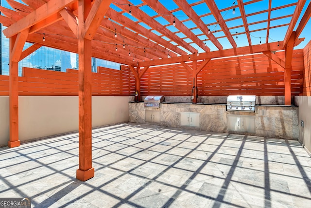 view of patio / terrace featuring exterior kitchen, a pergola, and a grill