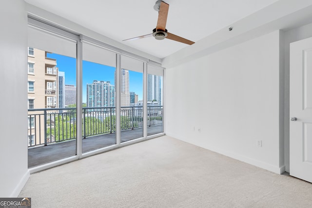 empty room with carpet flooring and ceiling fan