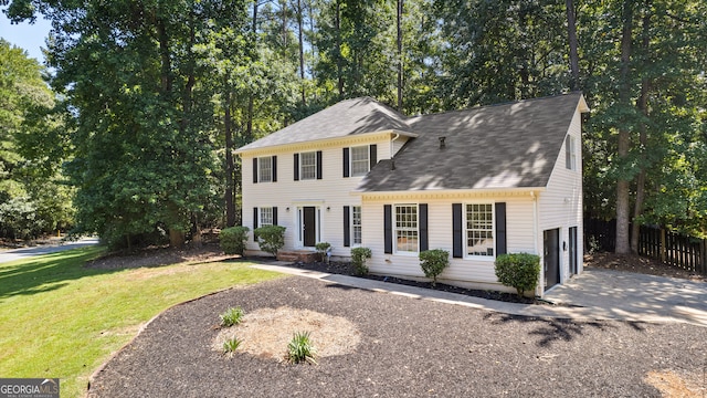 view of front of property featuring a garage and a front yard