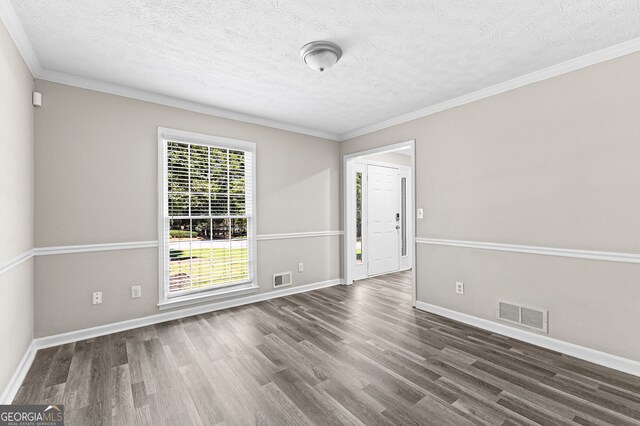 empty room featuring wood-type flooring and plenty of natural light