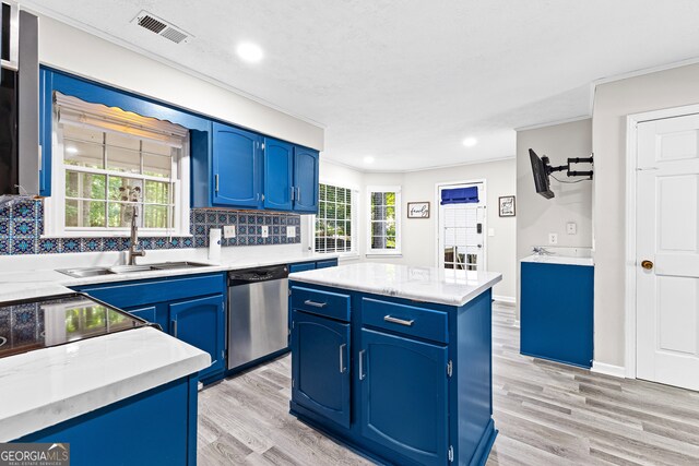 kitchen featuring sink, decorative backsplash, light hardwood / wood-style flooring, and dishwasher