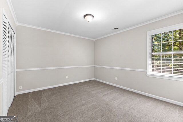 unfurnished bedroom with carpet flooring, multiple windows, and a closet