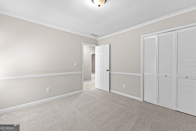 unfurnished bedroom with a closet, ornamental molding, and light colored carpet