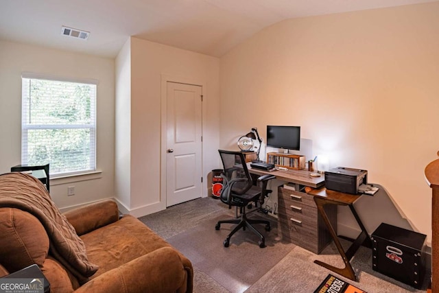 home office with dark carpet and vaulted ceiling