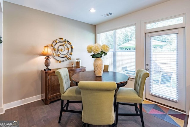 dining area featuring dark wood-type flooring