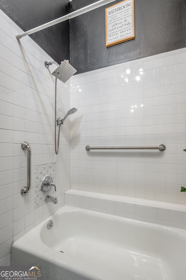 full bathroom with shower / washtub combination and a textured wall