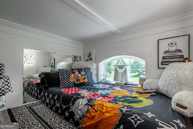 bedroom featuring ornamental molding and beamed ceiling