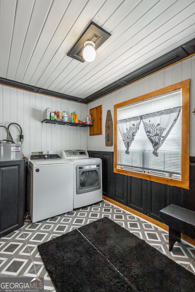 laundry area featuring laundry area, washing machine and dryer, and tile patterned floors