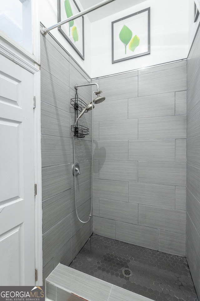 full bathroom featuring tiled shower