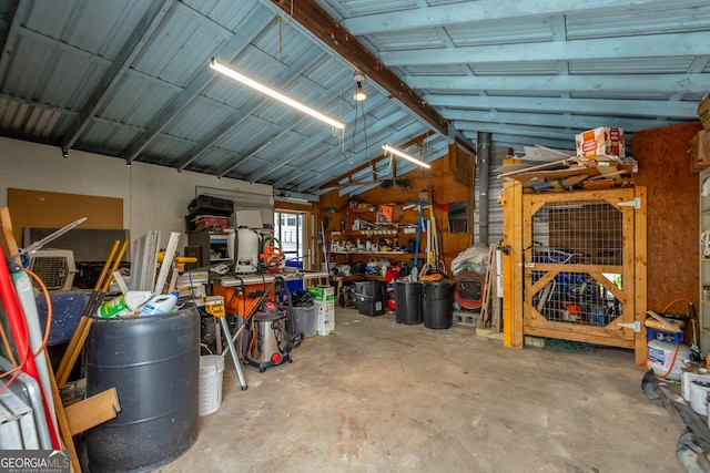 garage featuring a workshop area and metal wall