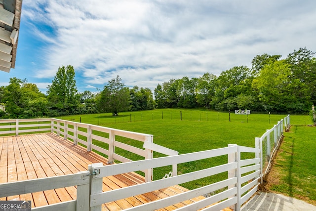 wooden terrace featuring fence and a lawn