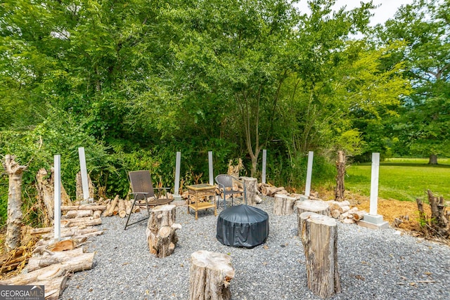 view of yard with an outdoor fire pit and a patio area