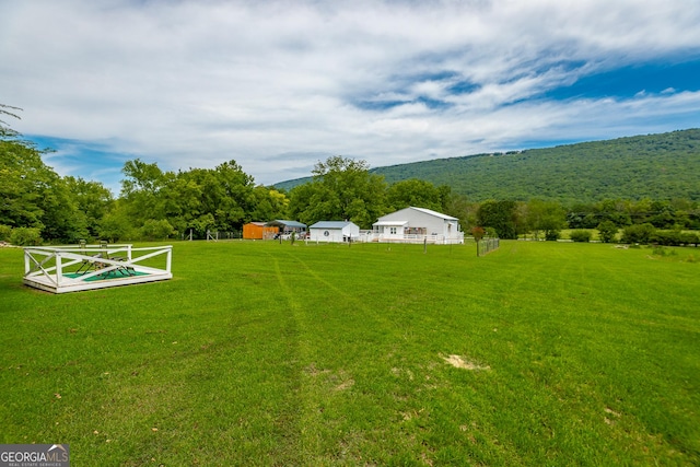 view of yard with a wooded view and a rural view