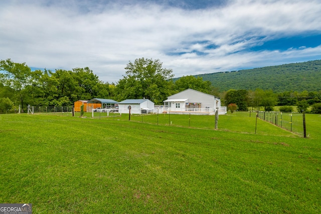 view of yard featuring fence and a rural view