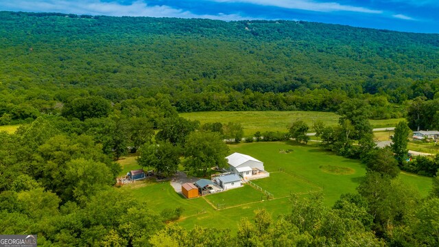 birds eye view of property with a rural view and a view of trees