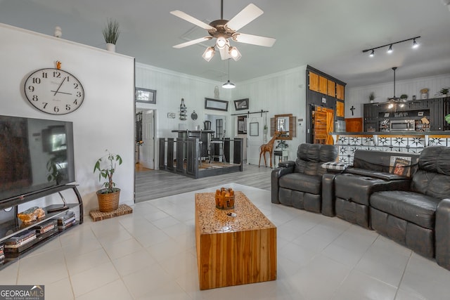 living room featuring ornamental molding, ceiling fan, and light tile patterned floors