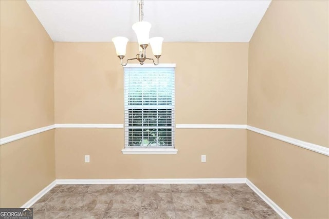 unfurnished room with tile patterned floors and a chandelier