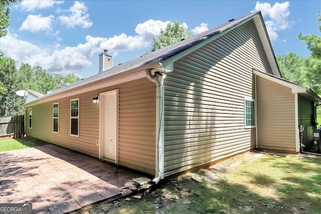 view of side of home with a patio area