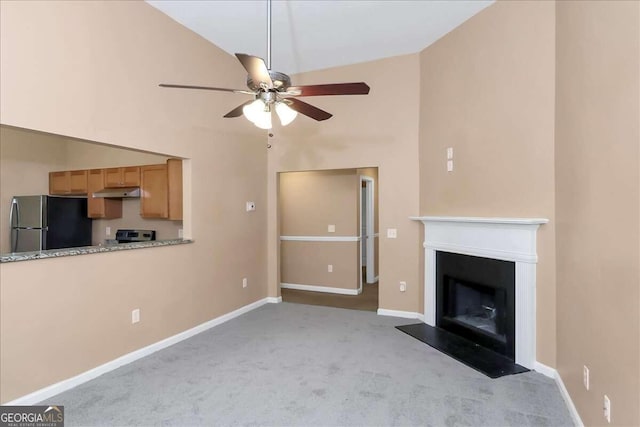 unfurnished living room with ceiling fan, high vaulted ceiling, and light colored carpet