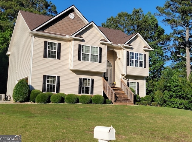 raised ranch with a front lawn